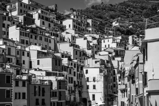 Captivating black and white image of traditional hillside architecture in Riomaggiore, Cinque Terre.