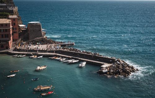 Free A picturesque view of Vernazza's harbor in Cinque Terre, Italy, with boats and the Ligurian Sea. Stock Photo