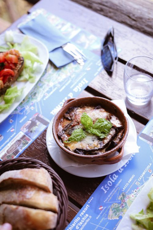 Free Delicious eggplant parmigiana served on a rustic Italian table, perfect for a Mediterranean meal. Stock Photo