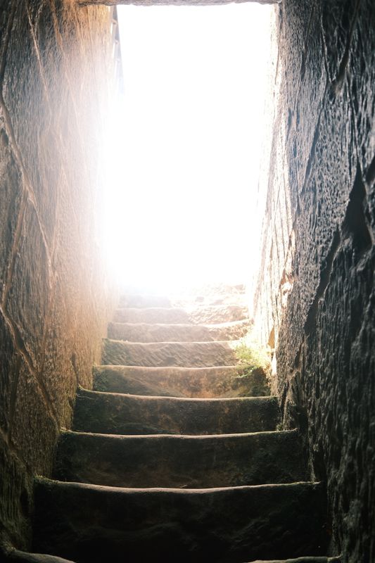 Worn stone steps climbing toward a bright opening - The Staircase Is Complete, Now Climb It