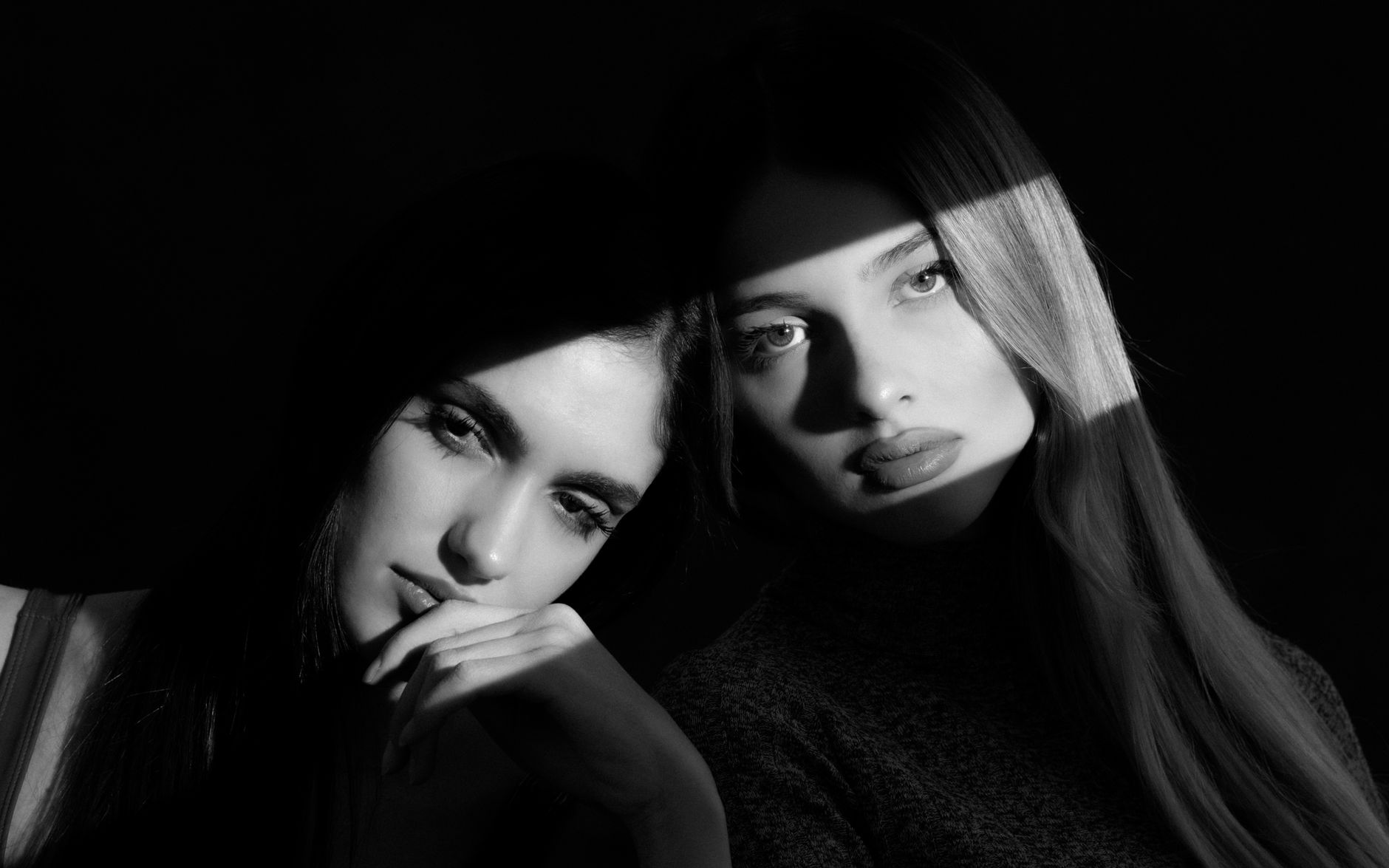 Dramatic black and white portrait of two women with striking lighting effects.. dramatic, black, white