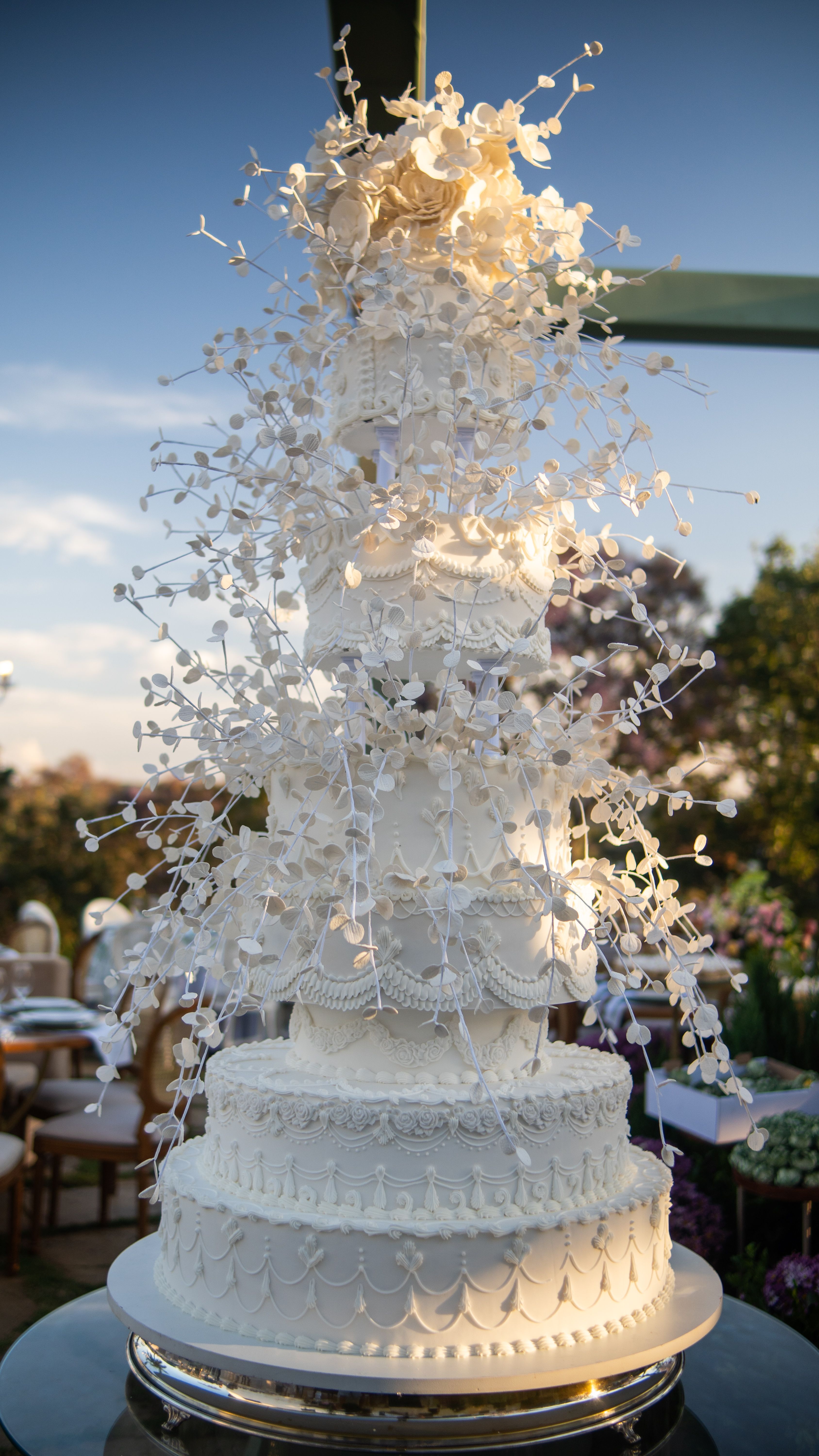 Multi-tiered wedding style cake with white floral decorations