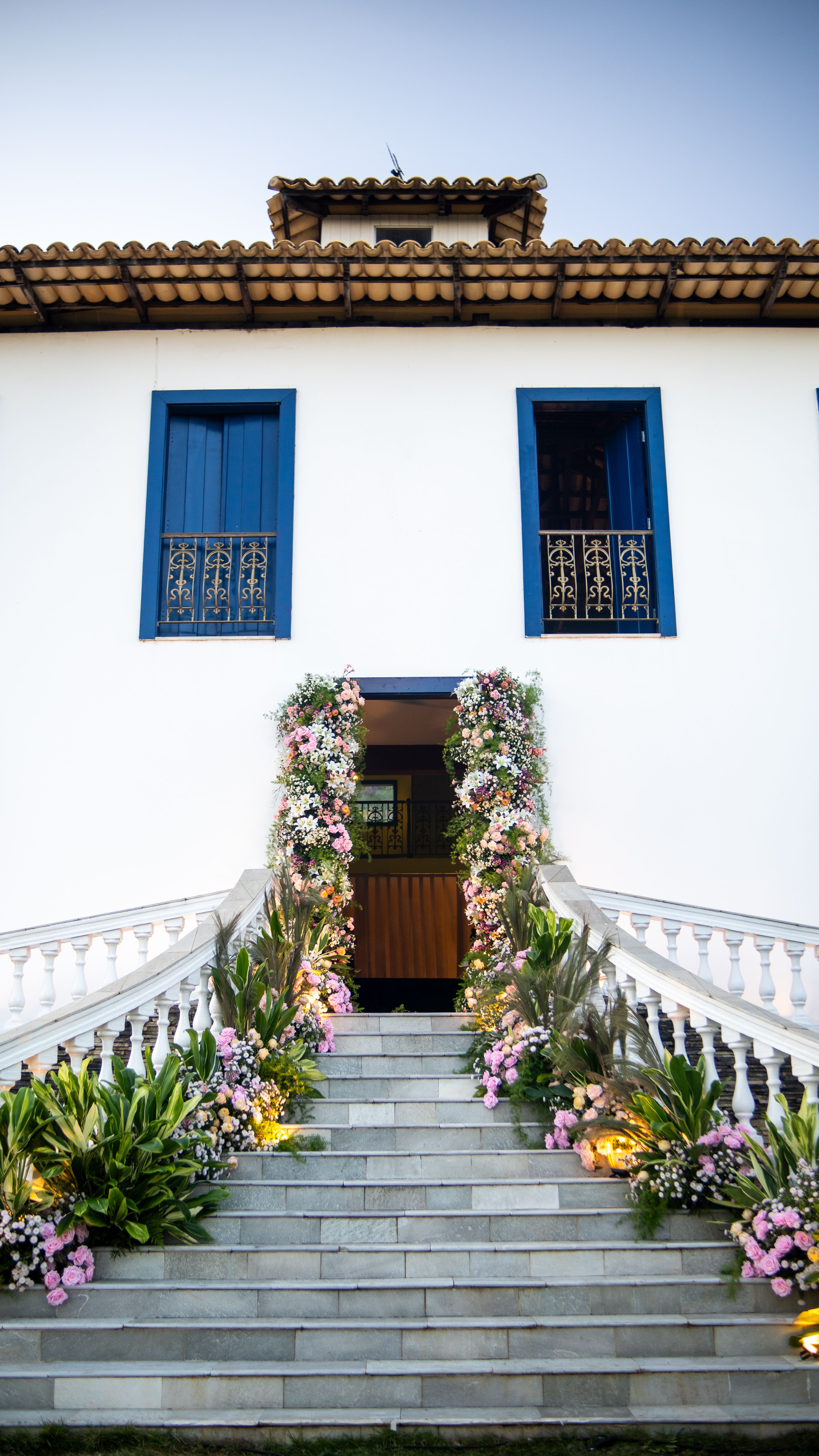Historic building facade with elegant floral-decorated staircase, perfect for weddings or events.