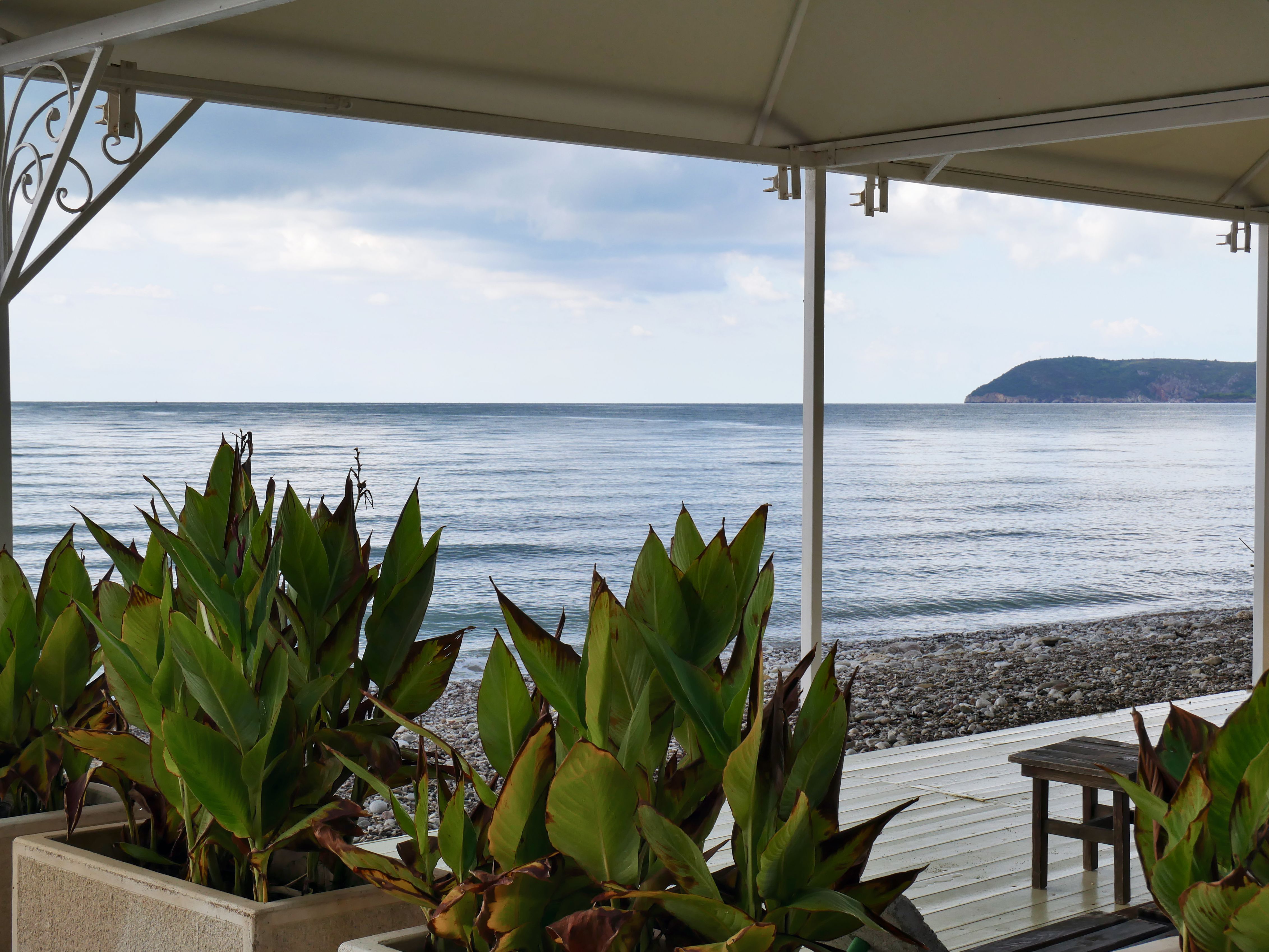 Shaded outdoor area at Sapphire Chambre with views to the beach