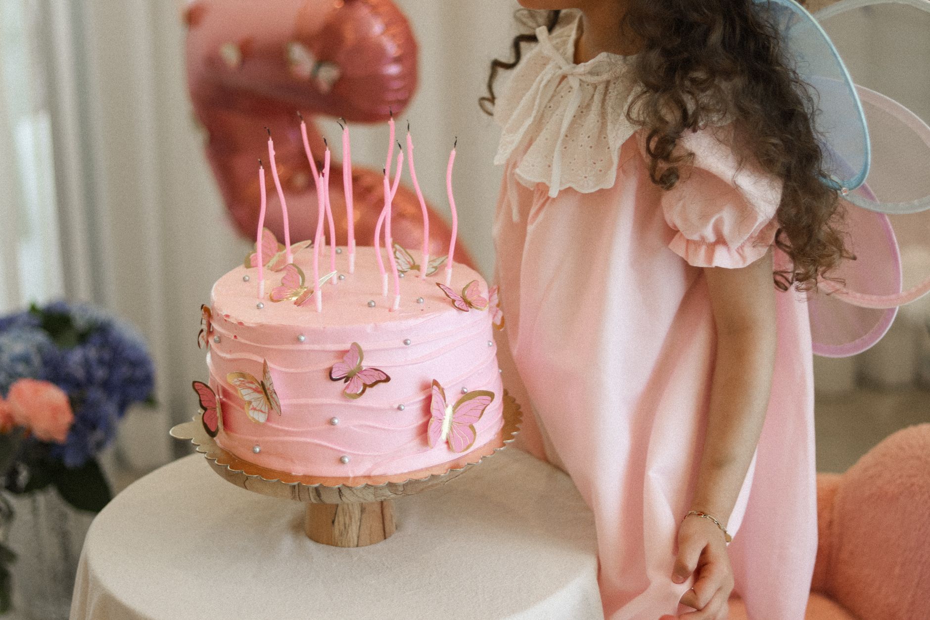 bespoke themed birthday Cairo — A fairy-themed birthday party with a pink butterfly cake and a young girl in costume.