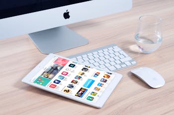 White Tablet Computer on Apple Magic Keyboard Near Apple Magic Mouse