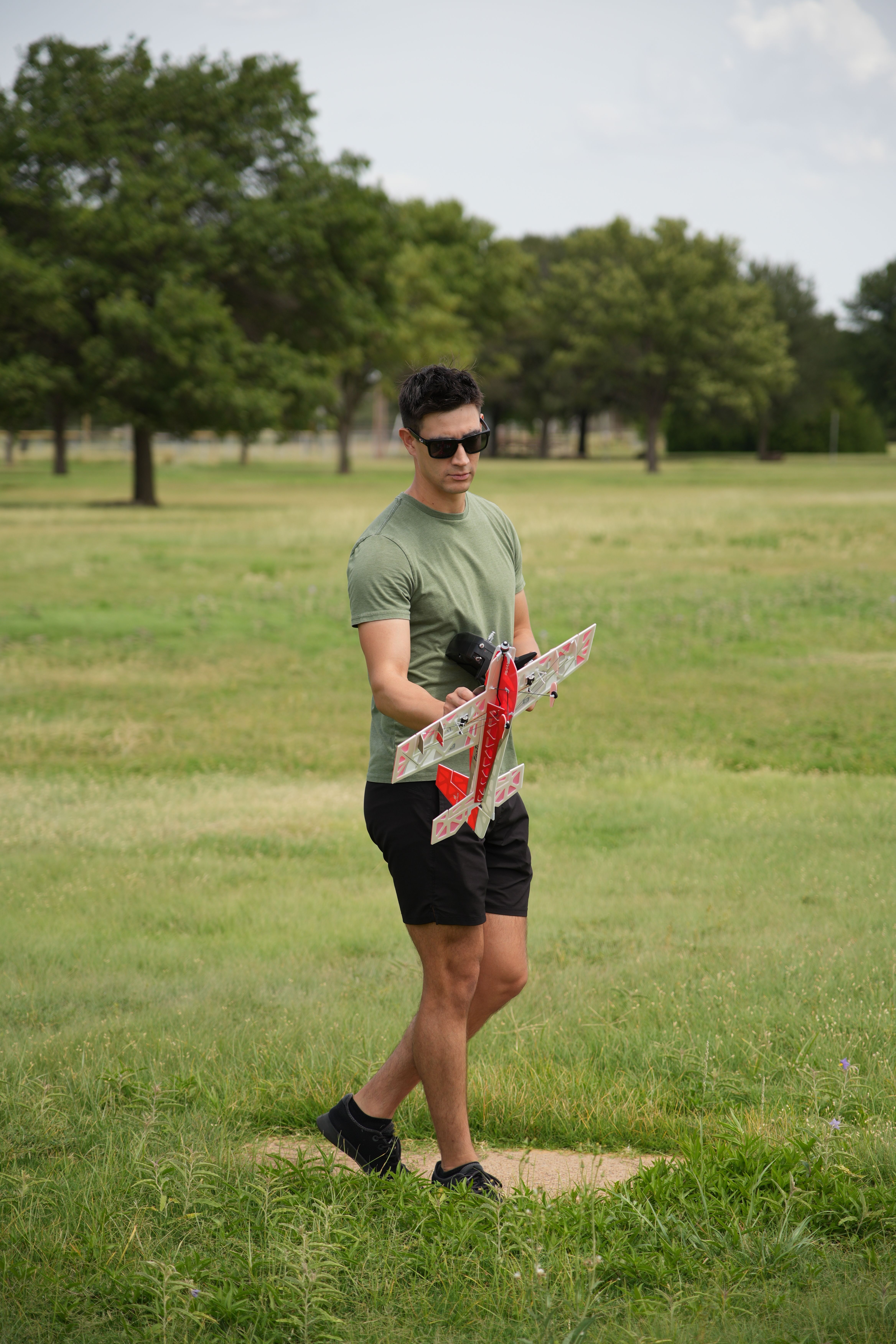 A man with a remote-controlled plane in a green park, Wichita Falls, Texas.