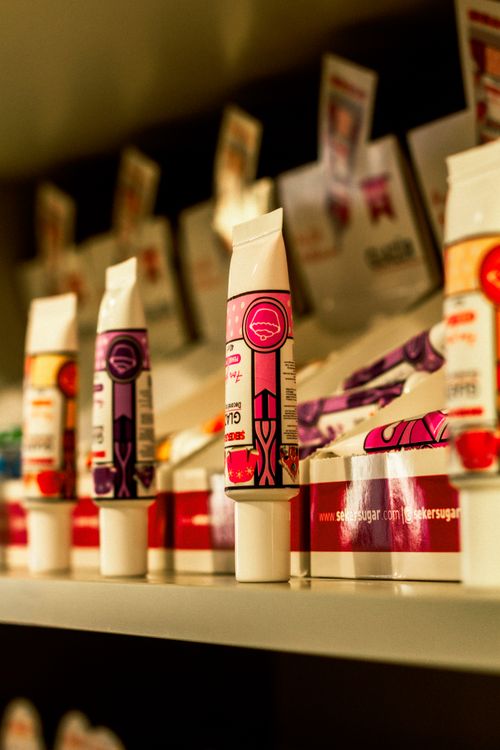 Free Colorful lip balms in vibrant packaging displayed on a store shelf. Stock Photo