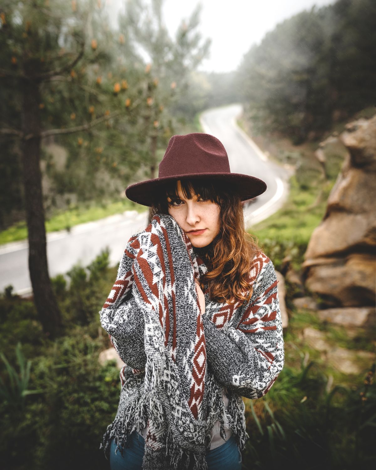 Stylish woman wearing statement hat and scarf