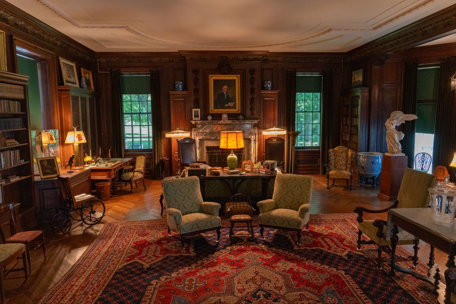 A quiet, oak-panelled chambers library with warm lamplight and shelves of bound volumes