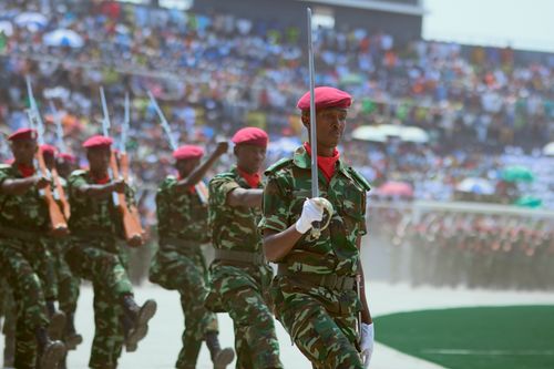 Free Soldiers in camouflage uniforms and red berets march in a military parade. Stock Photo