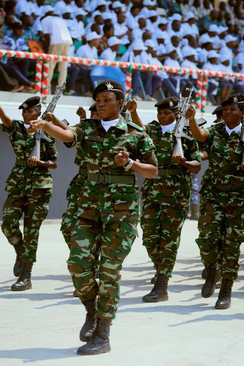 Free Group of soldiers in uniform performing a synchronized march in a public event. Stock Photo