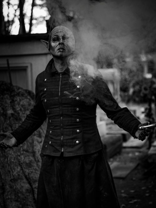 Free A dramatic black and white photo of a mystical figure exhaling smoke, creating a mysterious atmosphere. Stock Photo