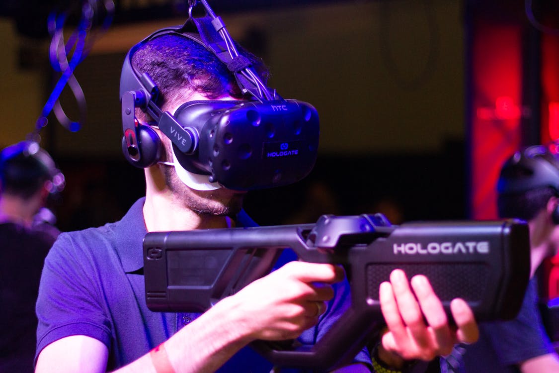 Free Man in VR with game riffle playing video game Stock Photo