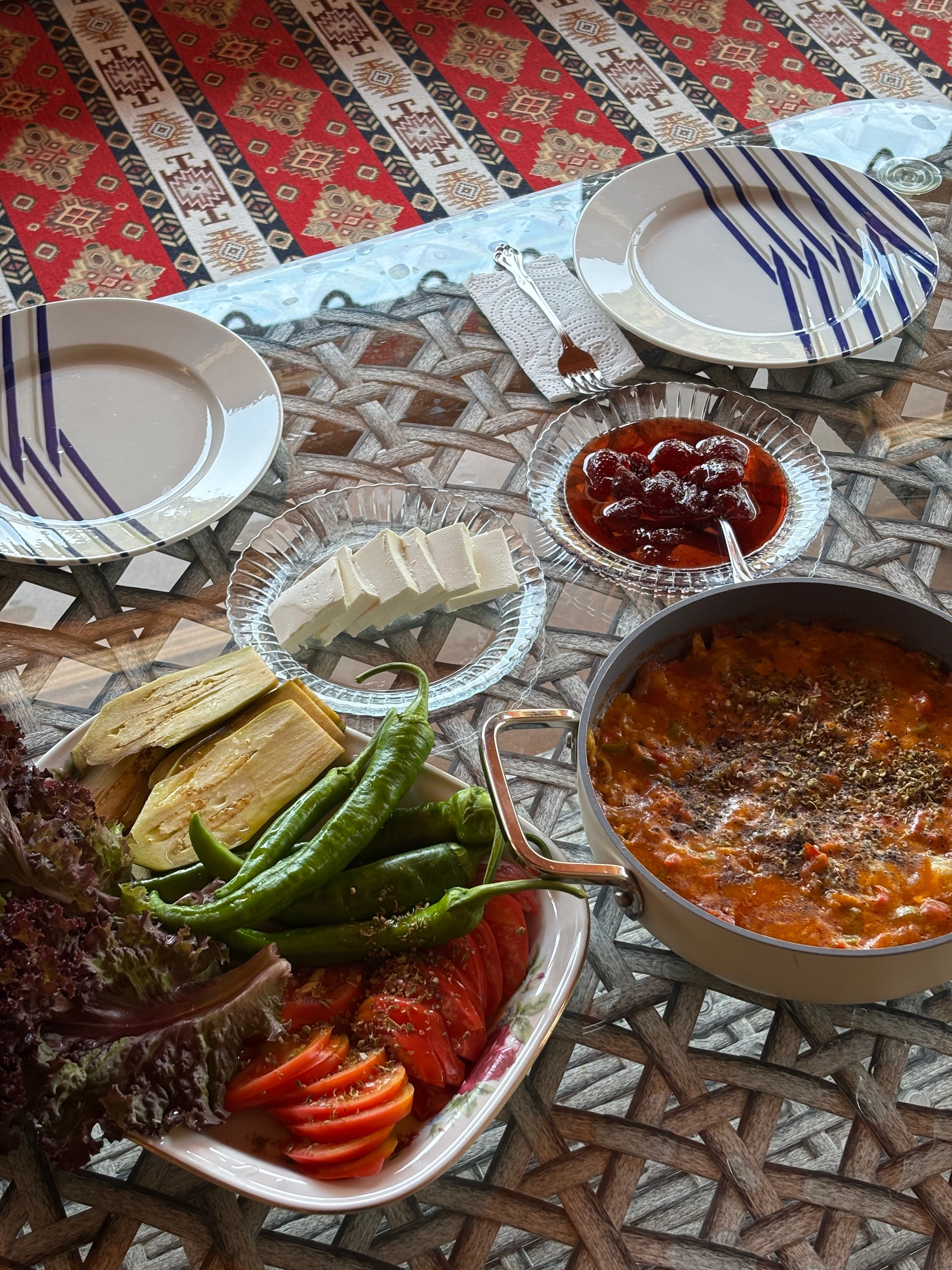 A vibrant Mediterranean meal spread featuring fresh vegetables and cheese, ready for sharing.