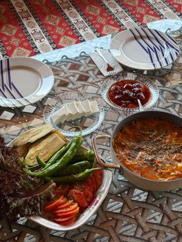 A vibrant Mediterranean meal spread featuring fresh vegetables and cheese, ready for sharing.