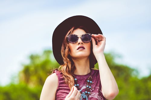 Free Girl in Pink  Tank Top Wearing Black Sun Hat and Black Sunglasses Stock Photo