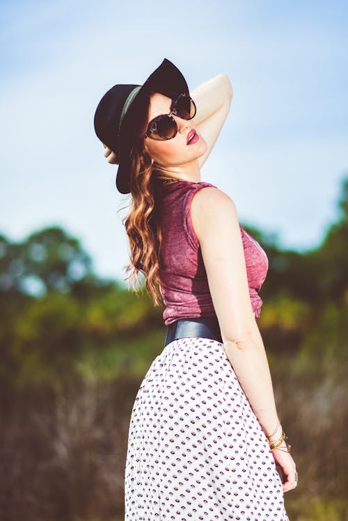 Free Woman in Pink Tank Top and White and Black Polka Dot Skirt Wearing Black Sunglasses Stock Photo