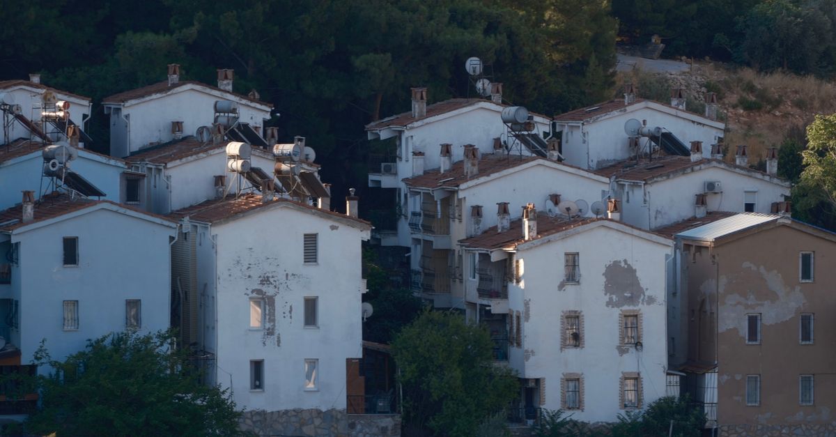 Charming view of rustic apartment buildings in İzmir, showcasing urban architecture with a natural backdrop.