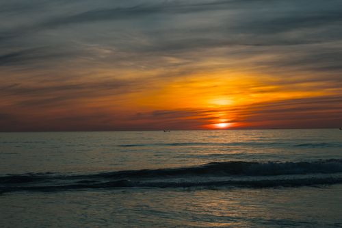 Free Breathtaking sunset over the calm ocean in Quảng Trị, Vietnam, with vibrant colors reflecting on the water. Stock Photo