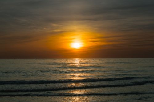 Free Beautiful sunset over the calm sea in Quảng Trị, Vietnam, capturing serene waters and golden skies. Stock Photo