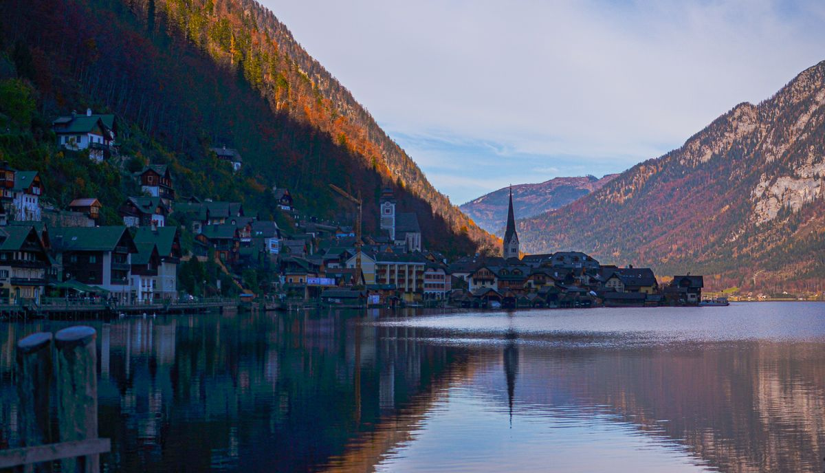Beautiful autumn landscape of Hallstatt, Upper Austria, reflecting in the lake.