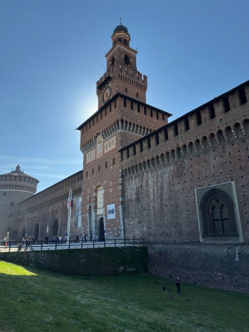 Free Sforza Castle's majestic tower in Milan, Italy, captured on a sunny day with clear blue skies. Stock Photo