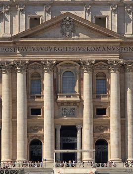 Close-up of St. Peter's Basilica's majestic front facade in Vatican City, showcasing its ornate columns and architectural detail.