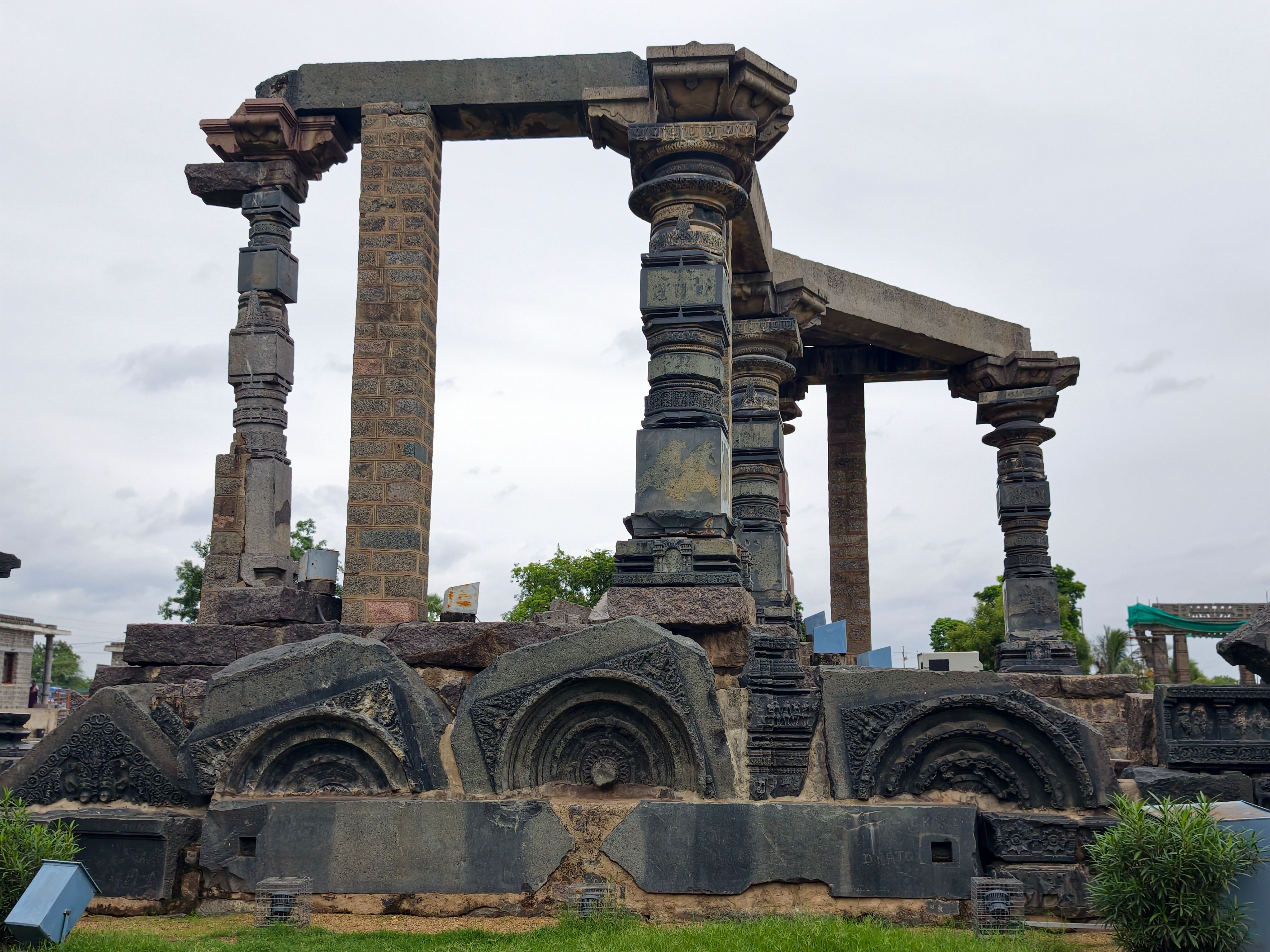 Explore the intricate stone carvings of ancient Indian temple ruins outdoors.