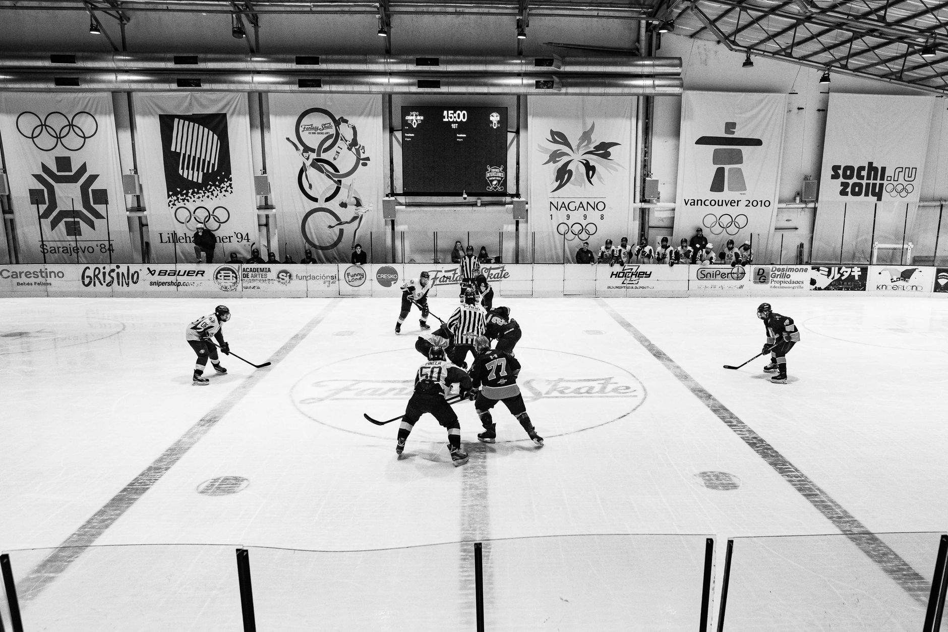 A dynamic ice hockey match underway in a Buenos Aires arena with players engaged in intense action.