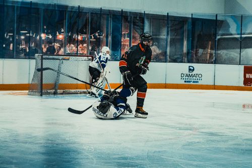 Free Action-packed ice hockey game in Buenos Aires with players in mid-action on the rink. Stock Photo