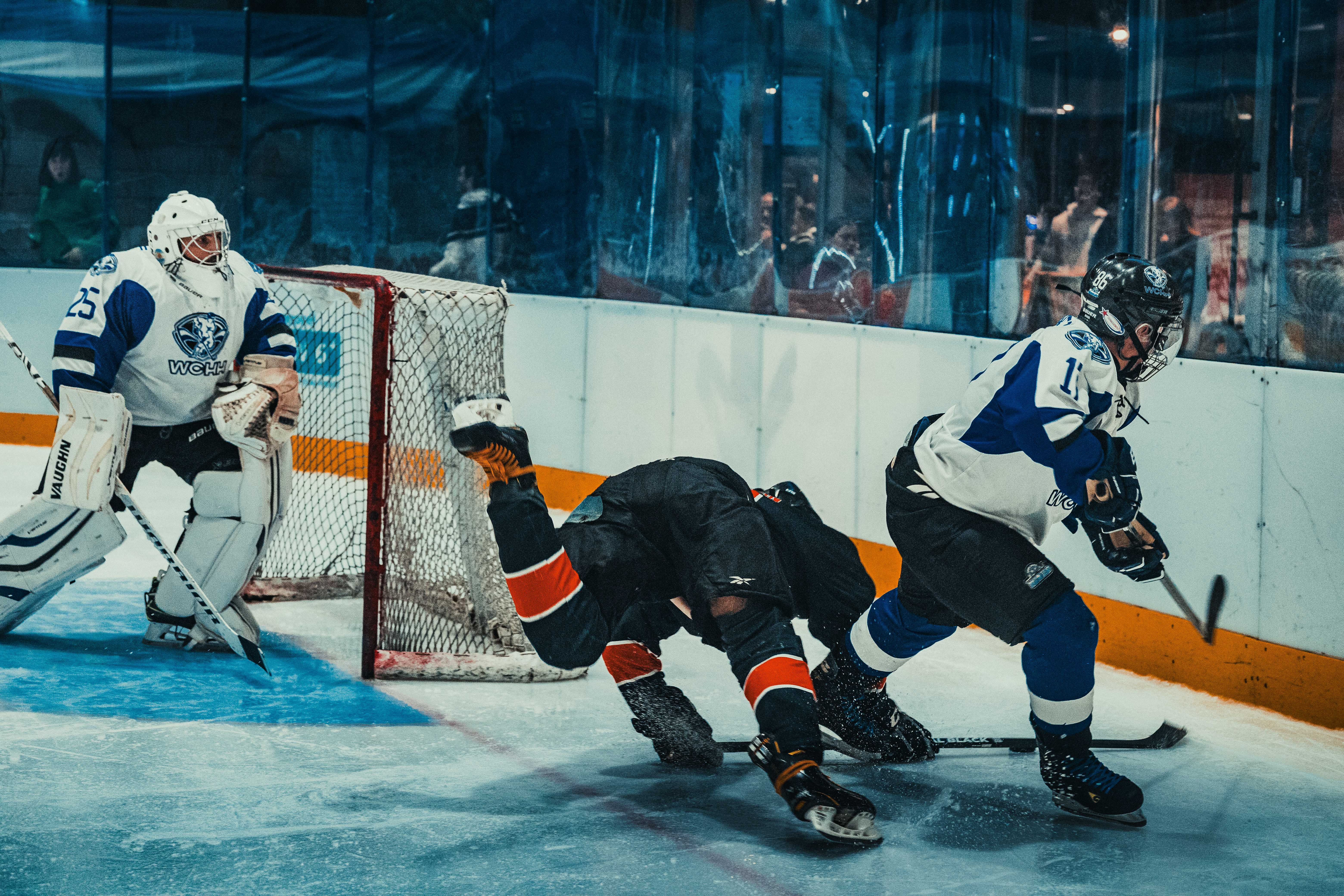 Dynamic moment in an ice hockey game with players competing near the goal during an intense match.