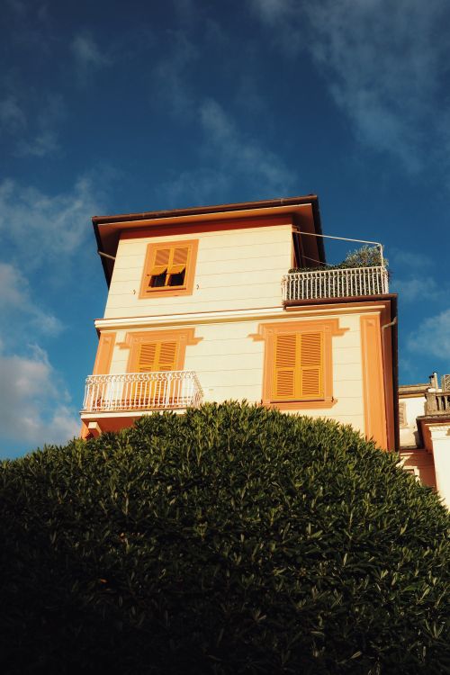Free Bright facade of a Mediterranean villa in Rapallo, Liguria against a clear blue sky. Stock Photo