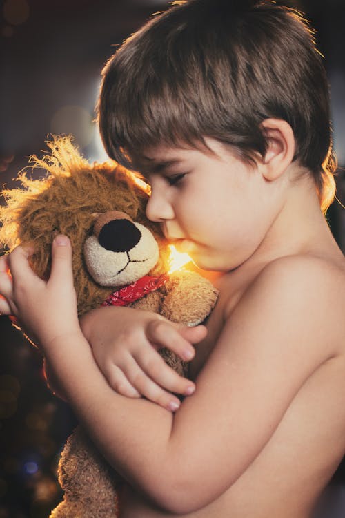 Boy Holding Brown Bear Plush Toy