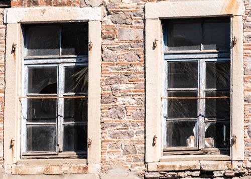 Free Close-up of vintage wooden windows on an old stone building facade in İzmir, Türkiye. Stock Photo
