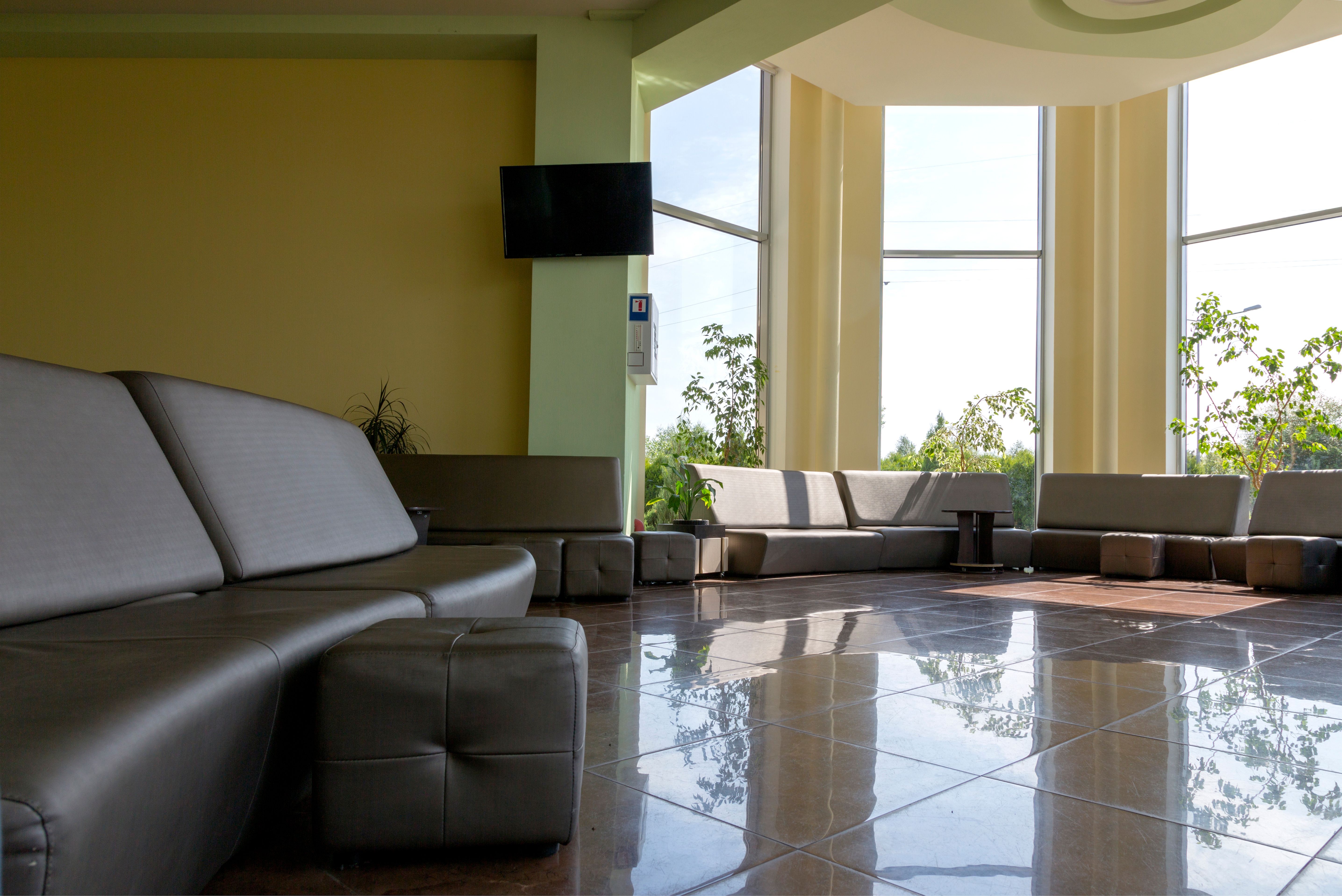 Spacious sunlit lobby and co-working common area with large windows and sleek seating