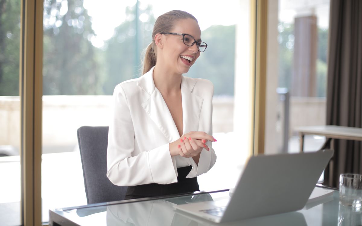 Businesswoman reviewing business funding plans on a laptop