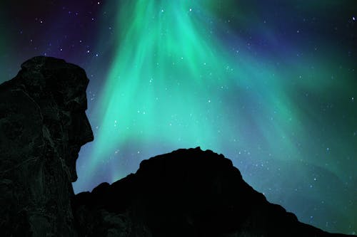 Free Aurora Borealis above a Mountain Stock Photo