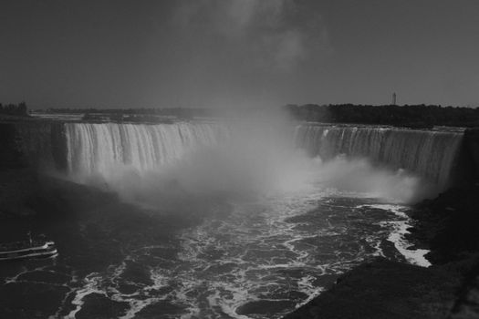 A stunning monochrome capture of the iconic Niagara Falls with mist rising dramatically.