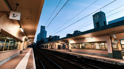 Free A deserted train station platform in Brussels, Belgium at dusk, with modern architecture. Stock Photo