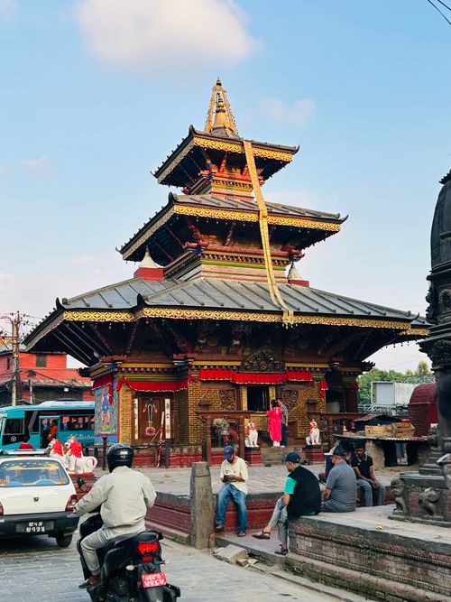 Free Scenic view of a traditional pagoda-style temple in Kathmandu with local people and city surroundings. Stock Photo