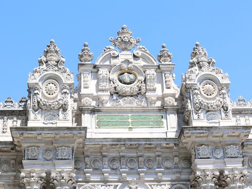 Free Intricate architectural details of Dolmabahçe Palace's facade against a clear sky. Stock Photo
