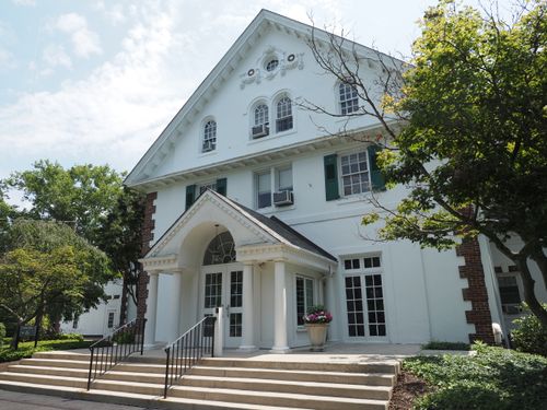 Free Elegant historic building facade with classical architecture in Doylestown, Pennsylvania, surrounded by lush greenery. Stock Photo