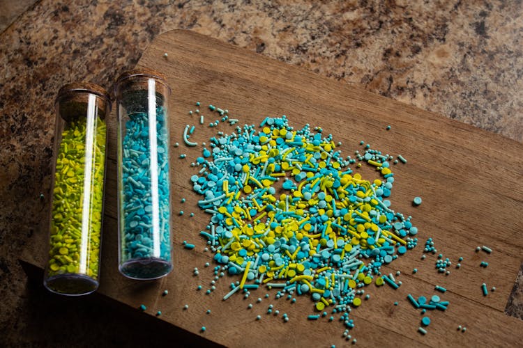 Blue And Yellow Sprinkles On A Cutting Board 