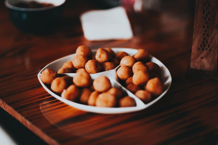 Roasted Salty Nuts On White Plate Served On Table