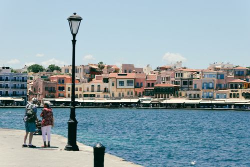 Free Picturesque harbor view in Chania, Greece, showcasing colorful buildings and a waterfront promenade. Stock Photo