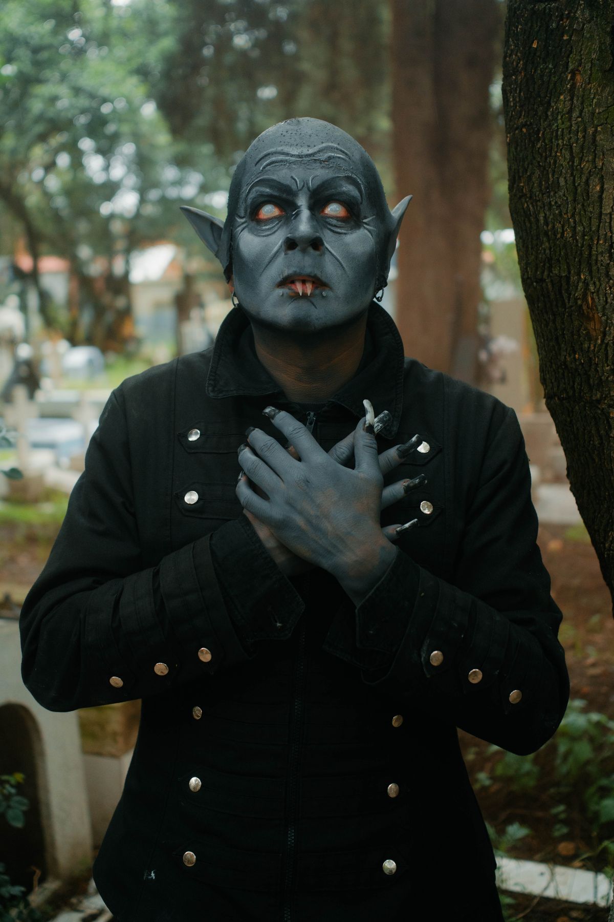 Nosferatu-style costume in a misty graveyard — full-commitment Halloween