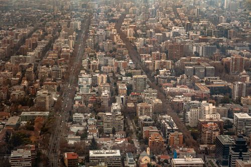 Free Aerial view of a sprawling urban cityscape with modern architecture and busy streets. Stock Photo