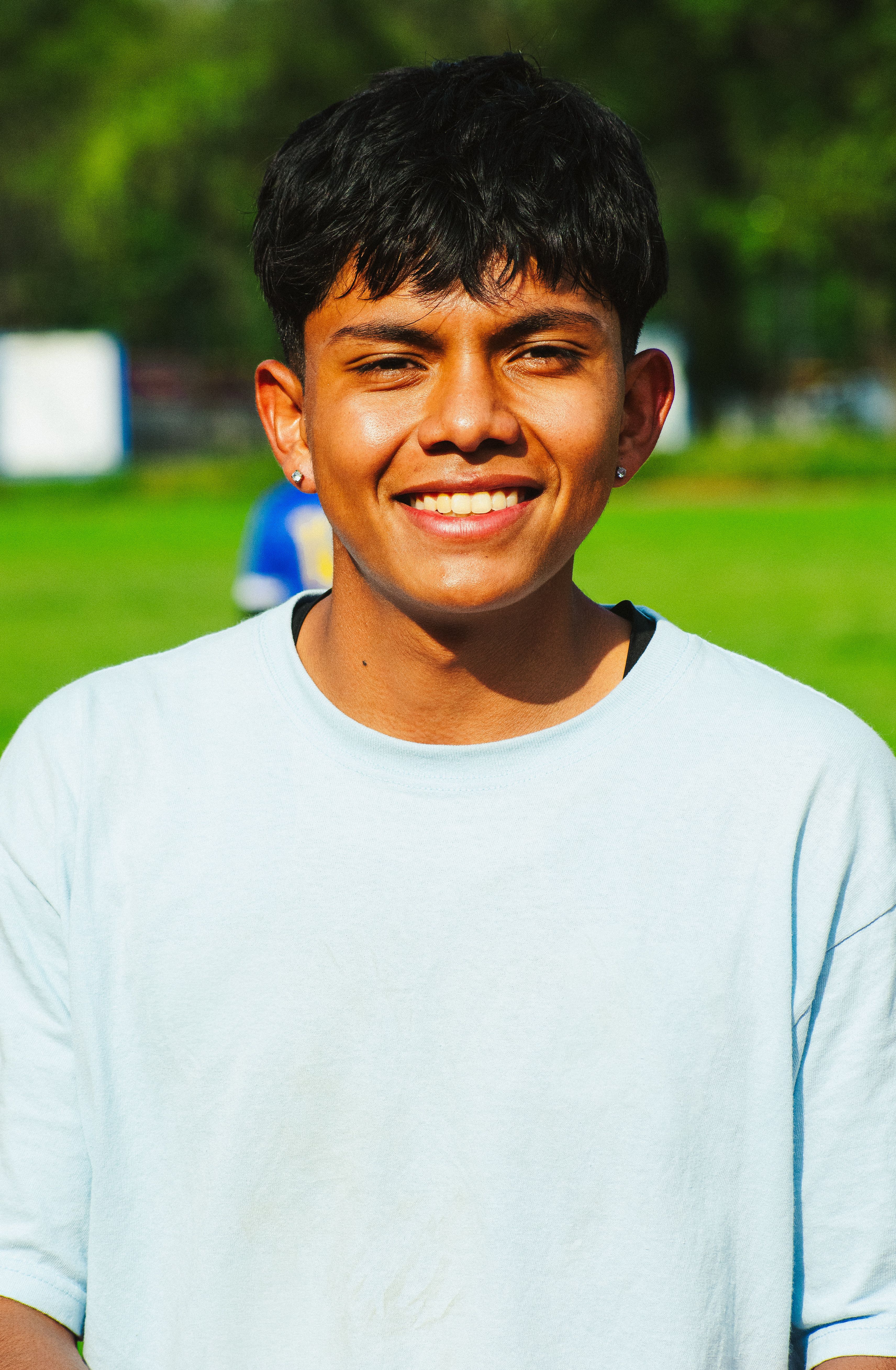 Portrait of a smiling young man enjoying a sunny day outdoors in Ciudad de México.