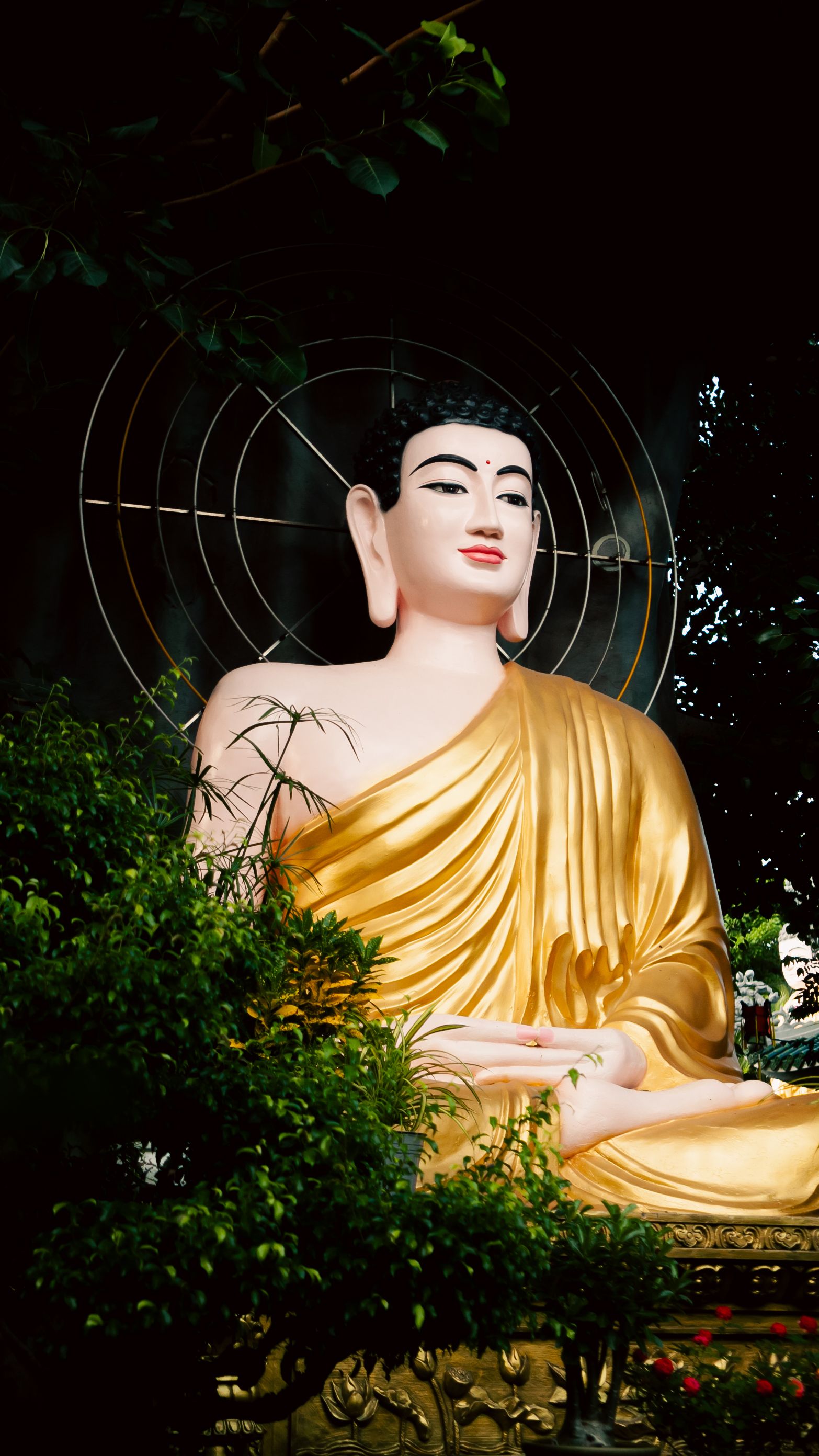 A striking golden Buddha statue surrounded by greenery in Đồng Nai, Vietnam.